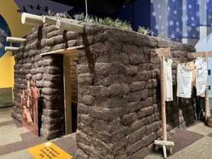 photograph of a replica sod house in the Minnesota Historical Society's Then, Now, Wow exhibit.