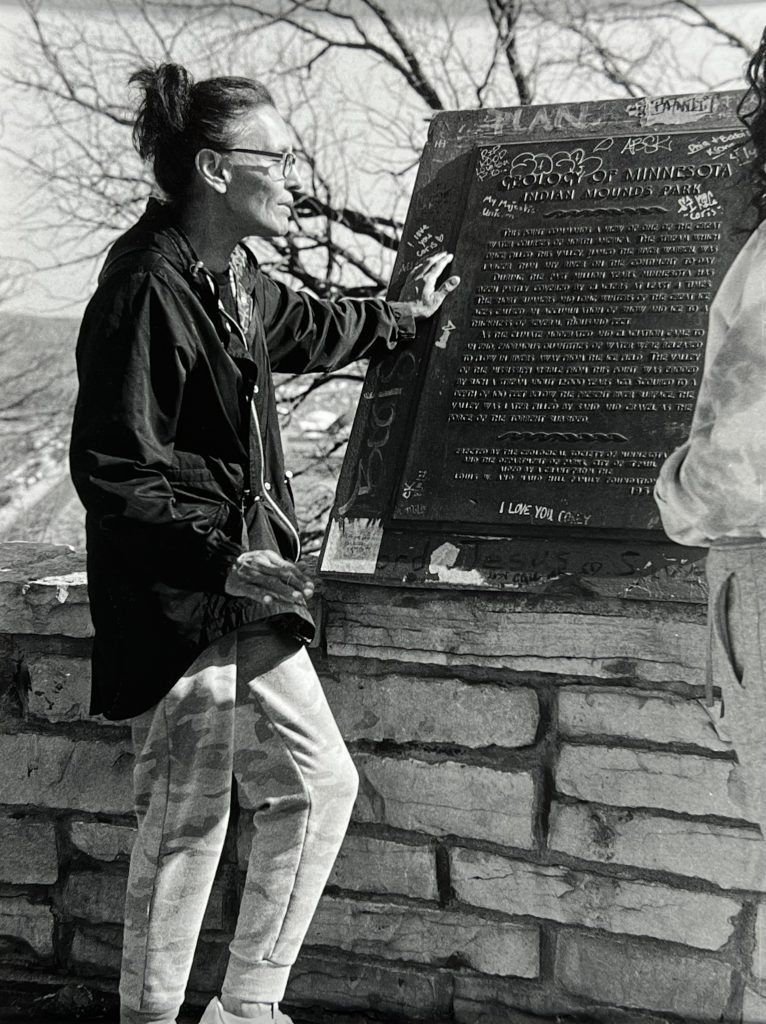 An Indigenous woman discusses a historical marker in Mounds Park, Saint Paul