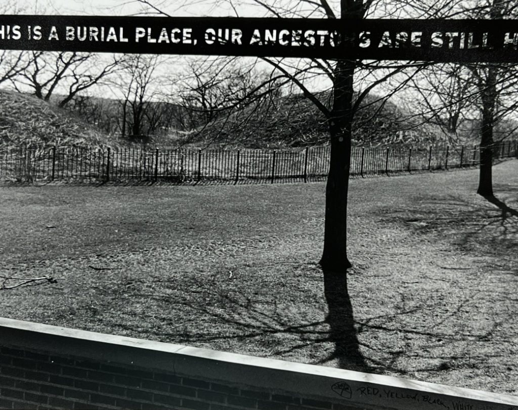 "This is a Burial Place, Our Ancestors Are Still Here" sign looking out over the burial mounds in Saint Paul's Mounds Park