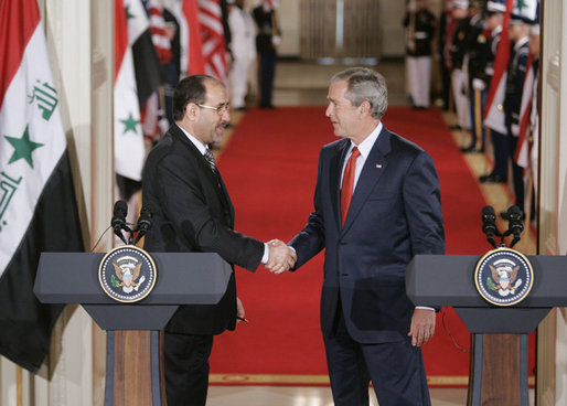 President George W. Bush shaking hands with Al Maliki