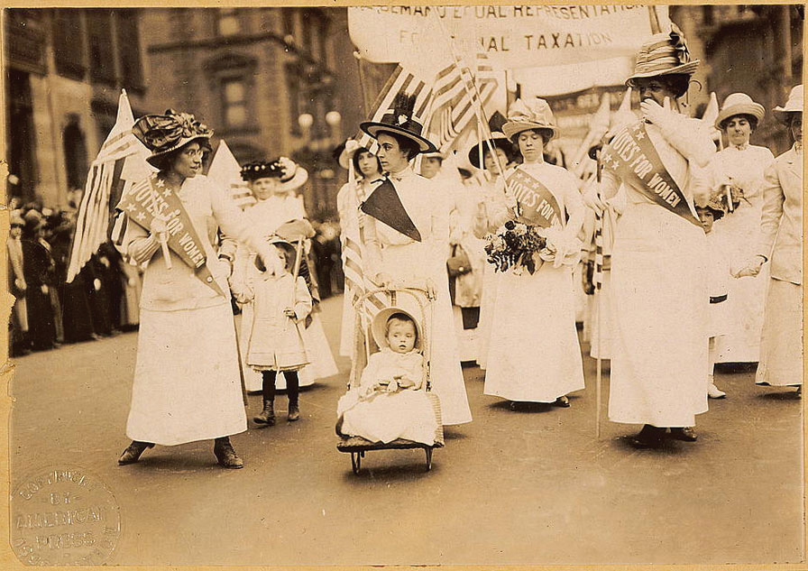 Suffragettes marching in a parade, fighting for the right to vote