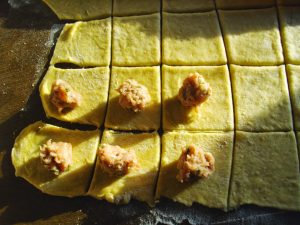 placing meatballs on rolled out dough