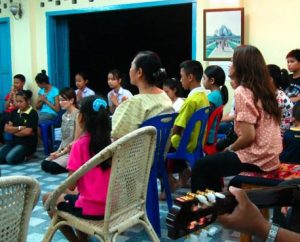 An assembled crowd sings songs at the National Baha'i Centre in Vientiane, Laos, in August 2009.