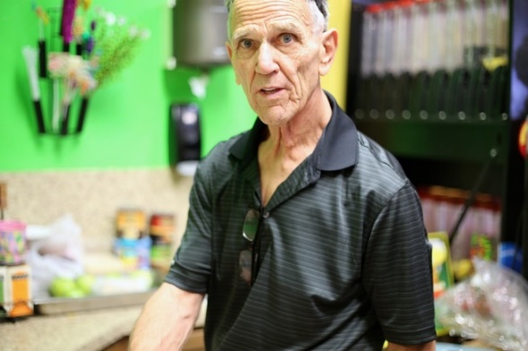 elderly man at work in a store.