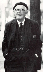 Elderly man with glasses wearing a suit and a beret cap.