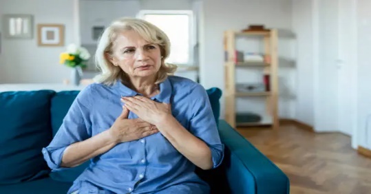 A person holding her hands on her chest