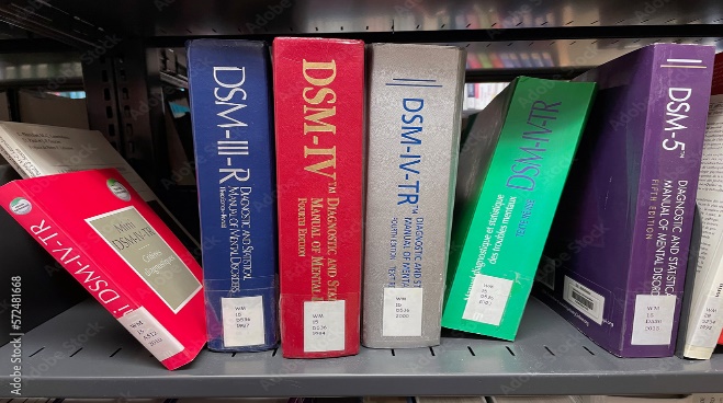 All of the editions of the DSM books on a bookshelf.