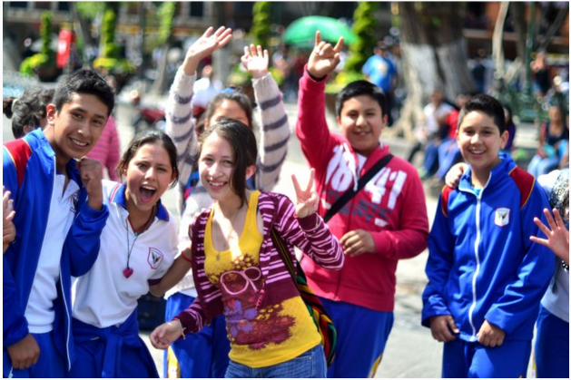 A group of young people at a gathering smiling at the camera