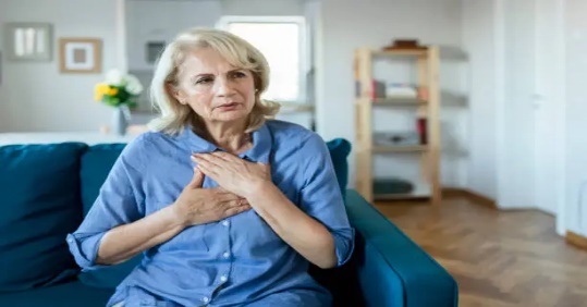 A person holding her hands on her chest