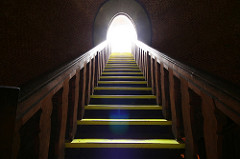 climbing stairs into light
