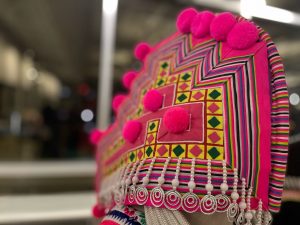 A bright pink traditional Hmong woven hat
