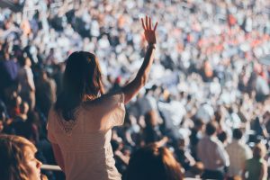 woman waves to crowd