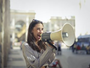 woman yelling into a megaphone