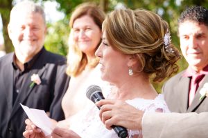 bride speaking into a microphone at her wedding