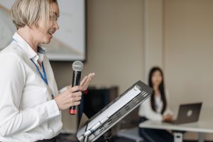 woman talking in a microphone