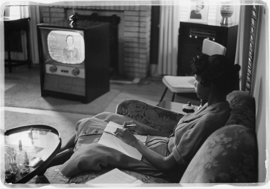 African American high school student being educated via television