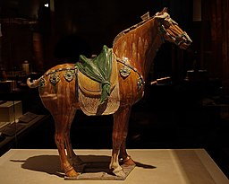 Exhibition "Treasures of China", Canadian Museum of Civilization, 2007. Tang Dynasty (A.D. 618 - 907) Excavated at Xi'an, Shaanxi Province, 1957 This yellow-glazed pottery horse includes a carefully sculpted saddle, which is decorated with leather straps and ornamental fastenings featuring eight-petalled flowers and apricot leaves.