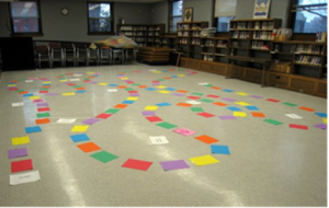 Library room with Candyland Squares laid out on the floor